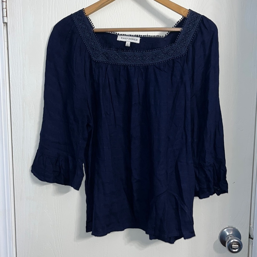 Like new Emily Daniel’s navy blue top with bell sleeve and design at neckline